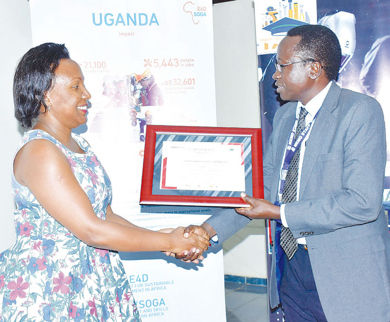 Tukacungurwa receiving her health and safety training certificate from Malinga during a stakeholders meeting in Kampala recently